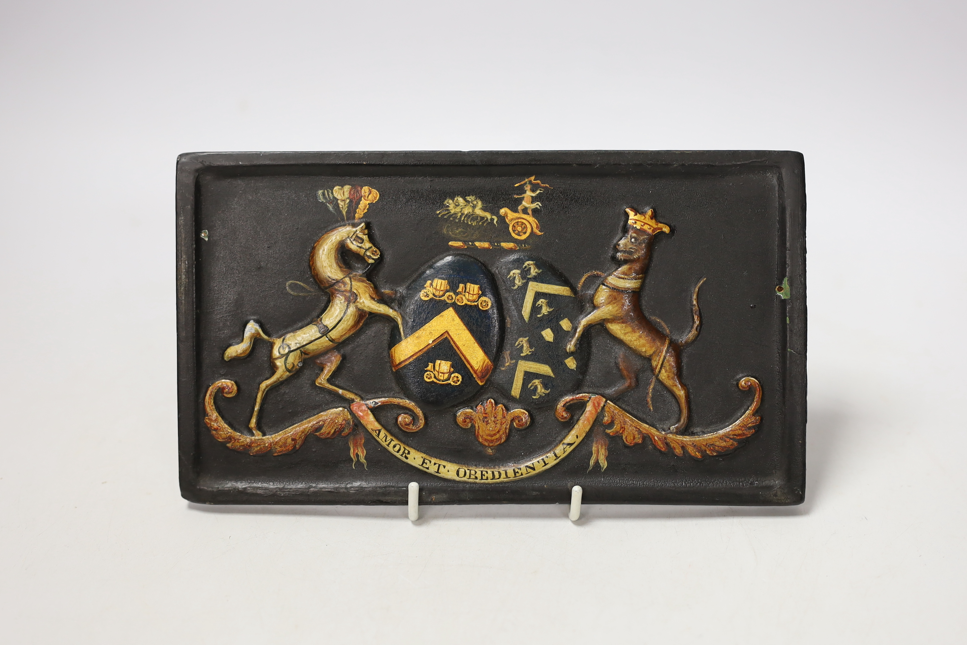 A 19th century painted and carved wood armorial coach panel, 12 x 21cm